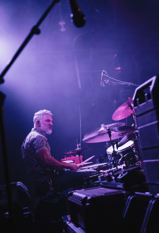 Close-up of Nick's hand and drumstick over a snare